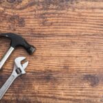 Tools on a table. Hammer and spanner.